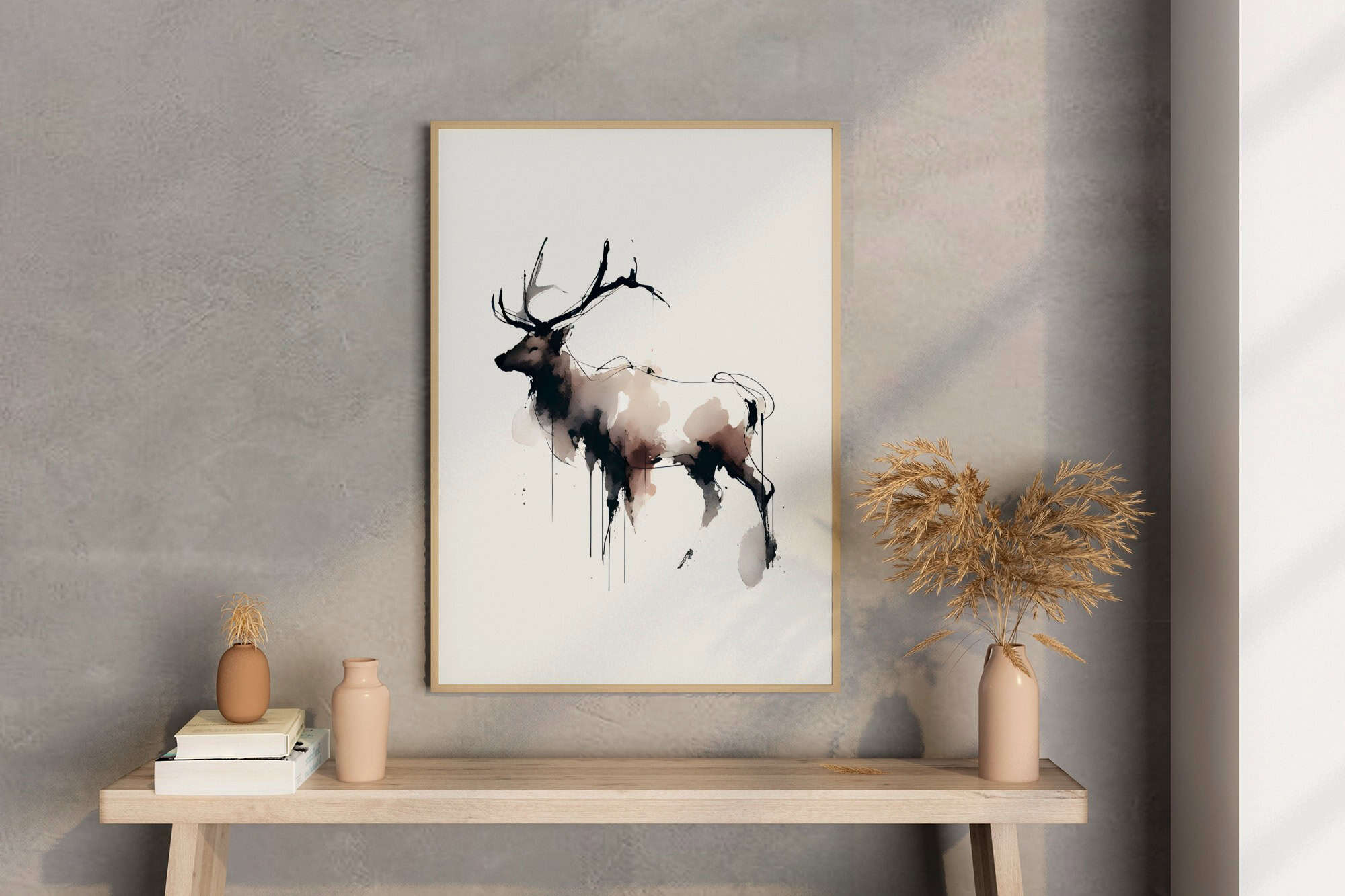 Minimalist interior featuring a framed abstract watercolor deer artwork in soft neutral tones above a simple wooden console.