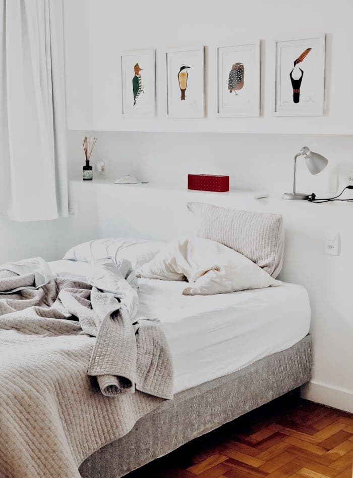 services-02 Contemporary bedroom design featuring art prints and cozy bedding for a warm ambiance.